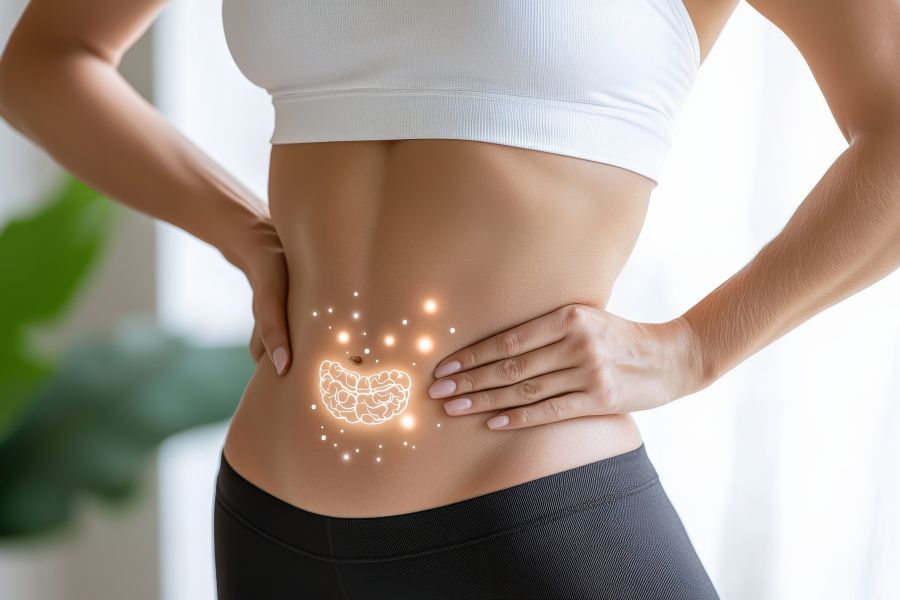 A woman with a her belly exposed and a small virtual image of a happy microbiome on top.