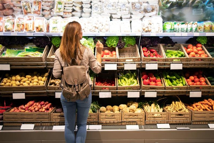 Women looking at fresh fruit and vegetables in the supermarket. Women looking at fresh fruit and vegetables in the supermarket.