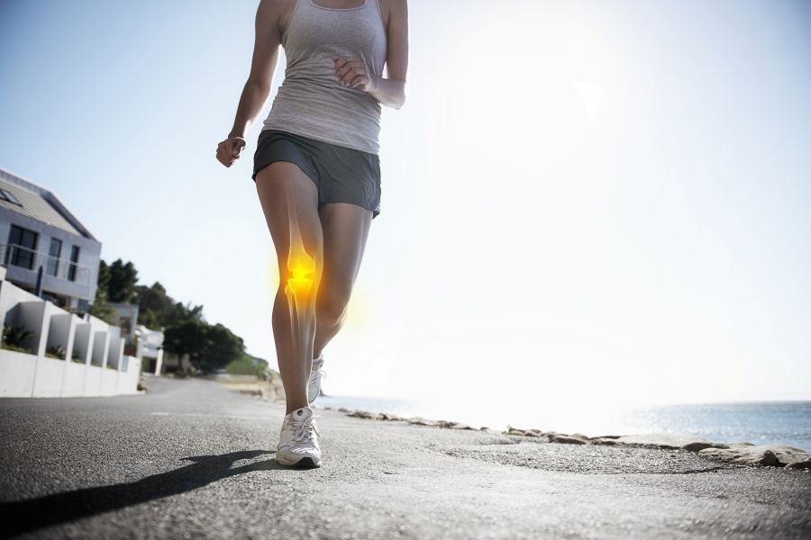 A woman runs with while her knee appears throught the skin as if an x ray.