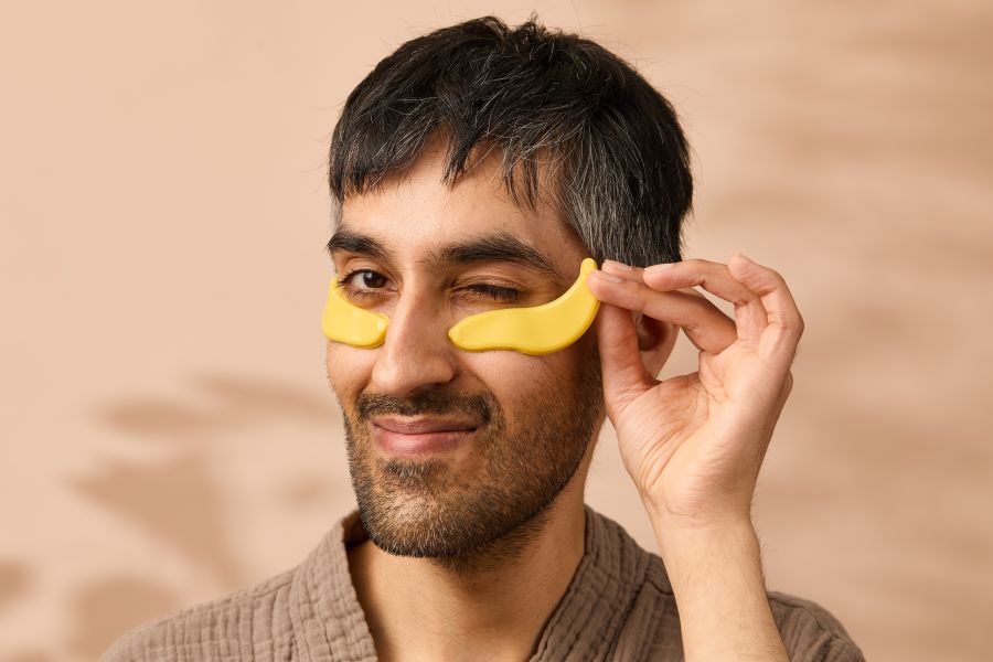 A man with an eye patch on his face in the shape of a banana. A man with an eye patch on his face in the shape of a banana.