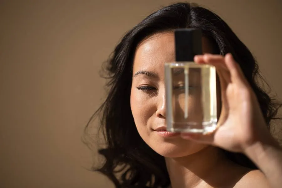Woman holding perfume bottle Woman holding perfume bottle