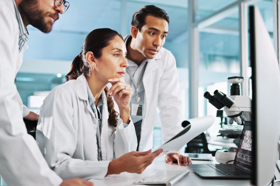 3 scientists on computer for breakthrough, clinical trial or discovery 3 scientists on computer for breakthrough, clinical trial or discovery