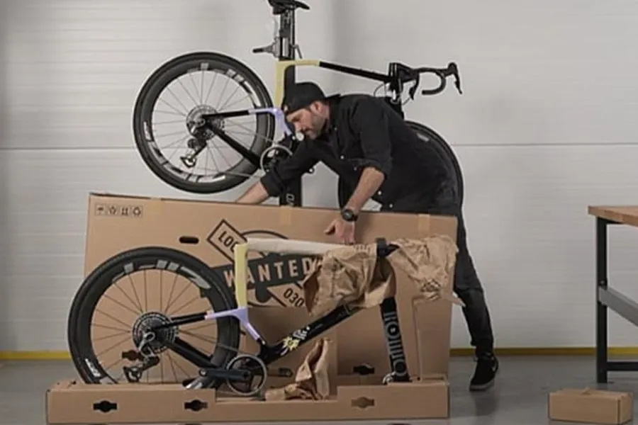 A man is removing the bike packaging made by Mondi. A man is removing the bike packaging made by Mondi.