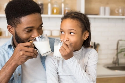 Father and daughter drinking milk.