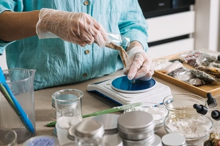 Hands making a natural beauty product.