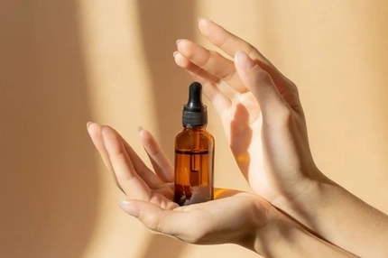 A person holding a bottle of liquid