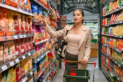 young woman in supermarket snacks aisle