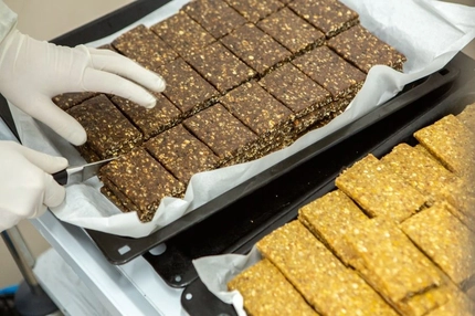 Image Factory worker cutting up protein bars