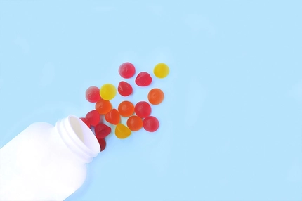 Image Multicolored jelly candies, vitamins scattered from a jar