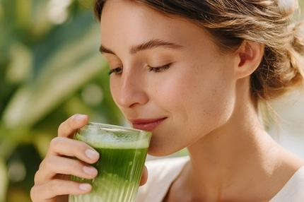 Person drinking matcha latte.