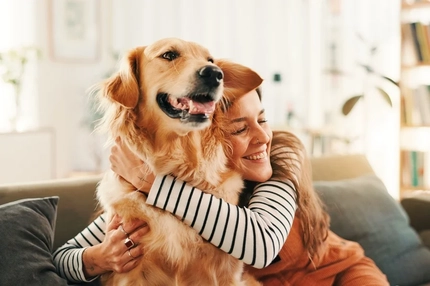 Woman hugging her golden retriever