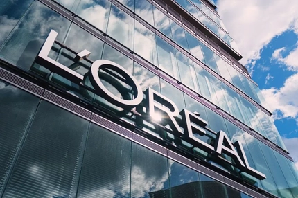 Image L'Oréal logo against a building in the sun