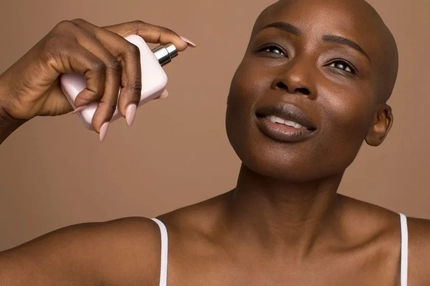 Image Woman spraying perfume