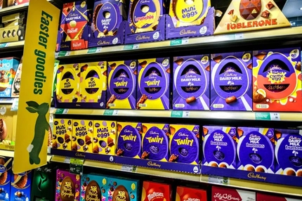 Cadbury Creme Eggs and other Easter goodies on a grocery store shelf.