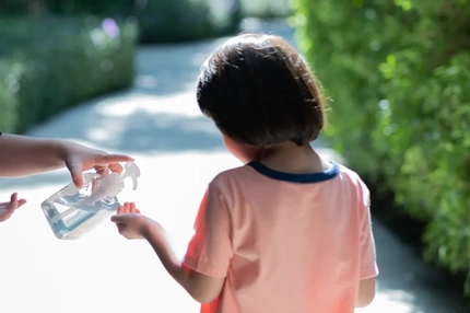 Image A child getting soap from a hand