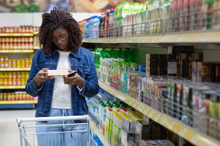 Image african woman reading food label in supermarket