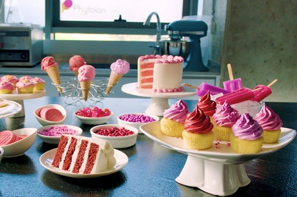 pink and red cupcakes and pastries on table