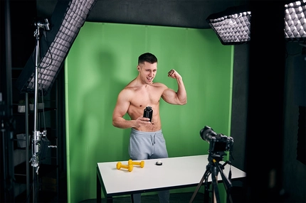 Athletic young man recording video for bodybuilding vlog