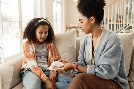 Image mother teaching daughter about pads