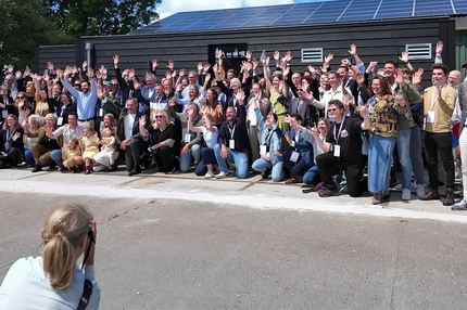 Image group at people posing for a team photo at farm