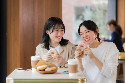 Two women happily eating reduced sugar sweets treats.