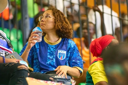 Image woman drinking water at football game