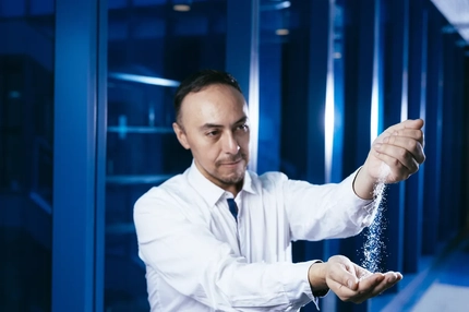 male scientist in lab coat with white powder