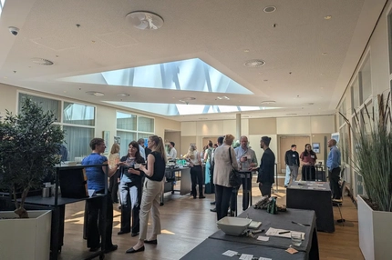 Image Crowd of people standing indoors, chatting and drinking coffee