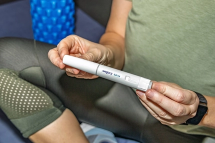 Person using GLP-1 weight loss medication.