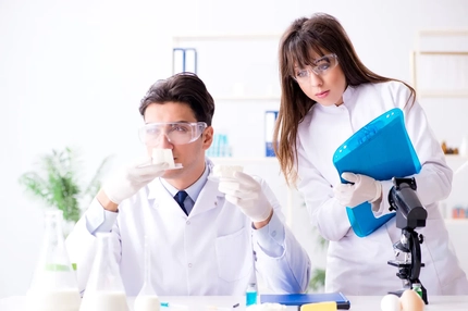 Image male and female scientist testing food in lab