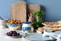 Food and glass jar with cream cheese on table.
