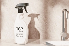 A spray bottle with a black handle