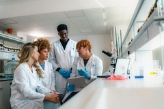 Researchers discussing in a lab