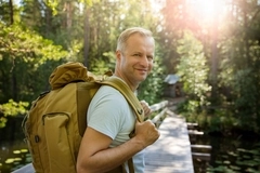 Hiker with big backpack traveling in forests Hiker with big backpack traveling in forests