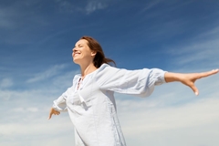 happy smiling woman enjoying weather with arms out