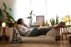 A woman lying on her couch.