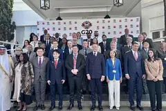 group of multi-racial people stand in rows for picture