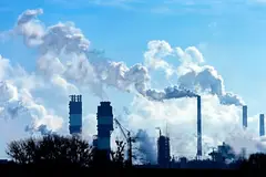 industrial pollution smoke in blue sky