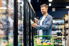 Man looking at food in the supermarket.