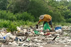 man picking waste up from