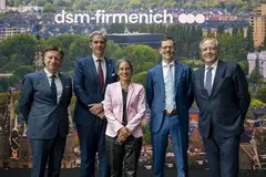 four men and a woman in suits at building innauguration