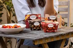 A person sitting at a table with food on it.