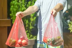 man holding plastic bags