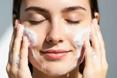woman cleansing her face