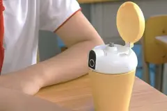 A student using a water bottle