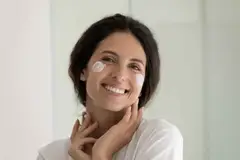 latin american woman using skin care