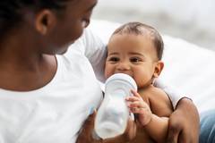 An infant bottle-feeding.