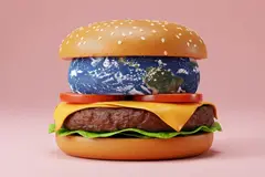 cheeseburger with planet Earth as a patty, symbolizing overconsumption and ecological issues