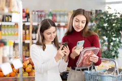 women looking at QR code