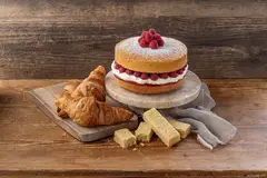 cake and croissant on brown table